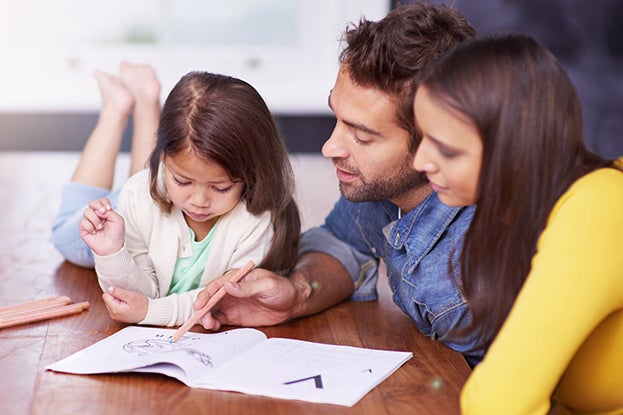 Parents teaching their child to read using phonics