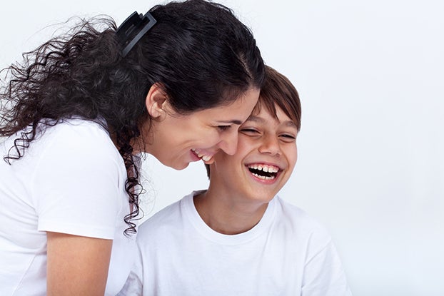 Mother and son sharing a funny moment laughing with joy