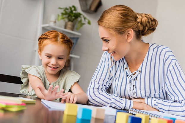 Mom working with 1st grade math with daughter