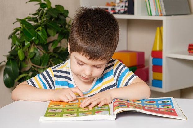 Young kid practicing print awareness