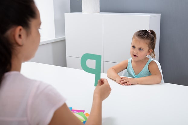 Mom helping daughter with segmenting words