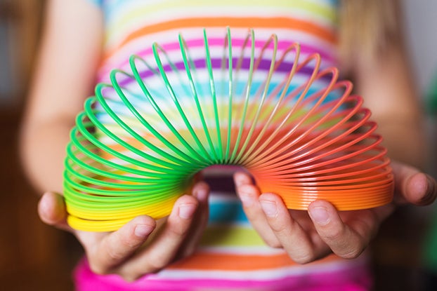 kid playing with slinky