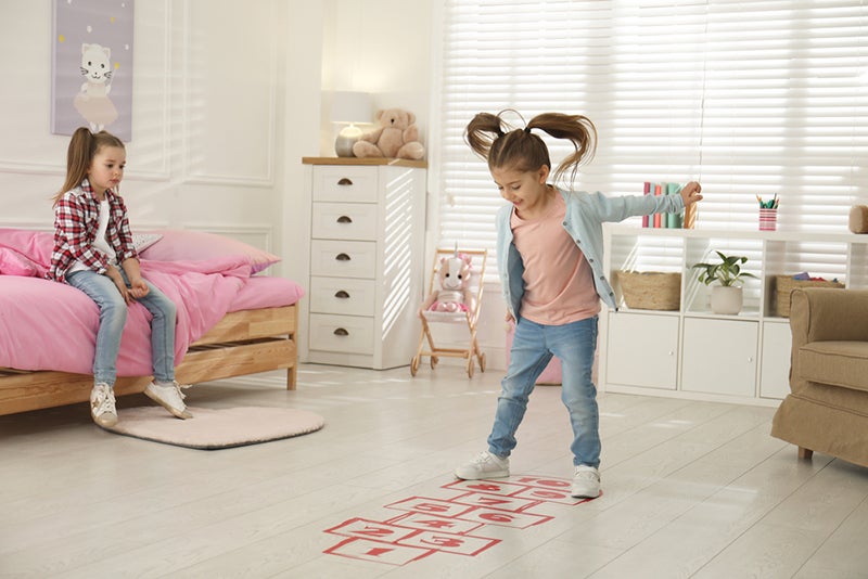 Girl playing hopscotch in playroom