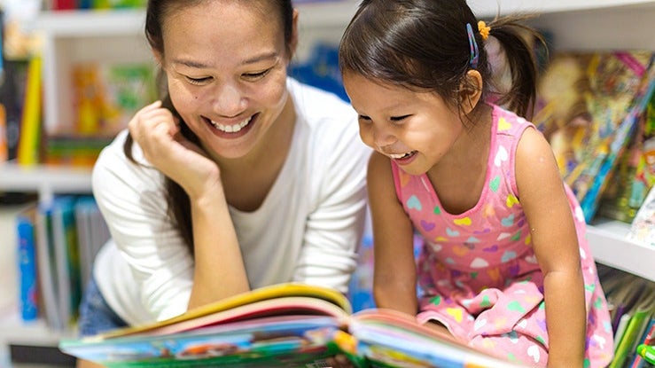 Mom teaching kid the letters in the alphabet
