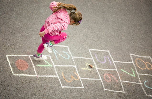 Kid playing hopscotch