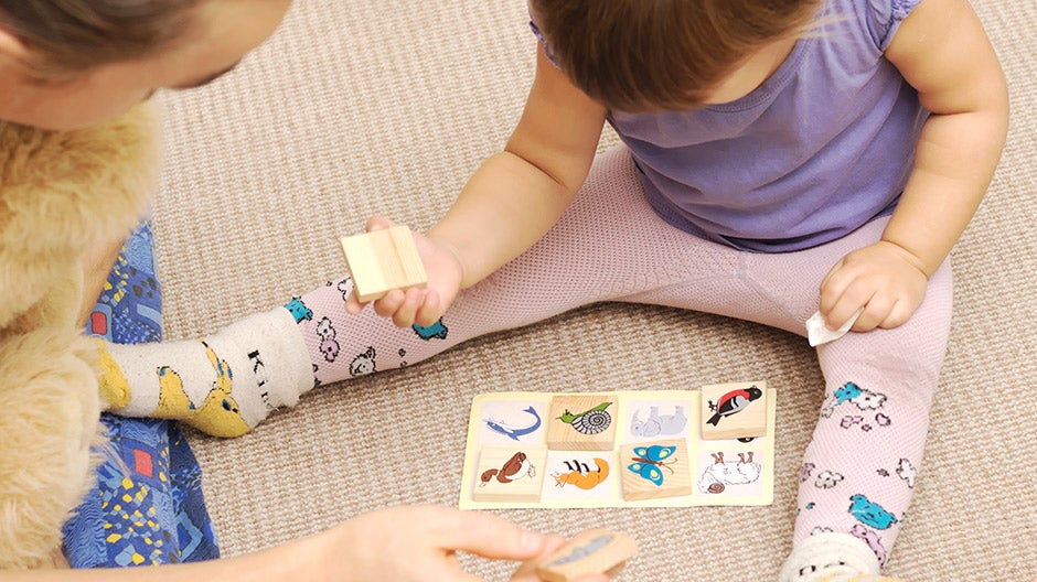 Toddler playing bingo on the floor