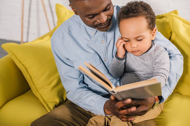 Father working with child on emergent literacy