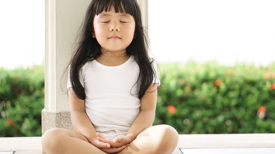 Child doing breathing and meditation exercises