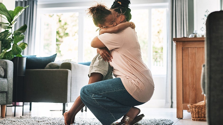 Mom hugging daughter after temper tantrum