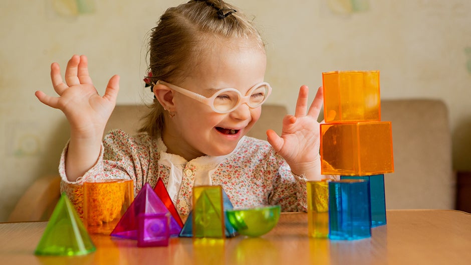 Child playing with magnetic tiles to support brain development