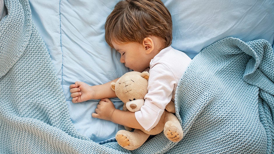Sleeping toddler with teddy bear