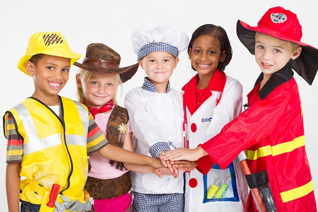 a group kids dressed up on costumes for pretend play