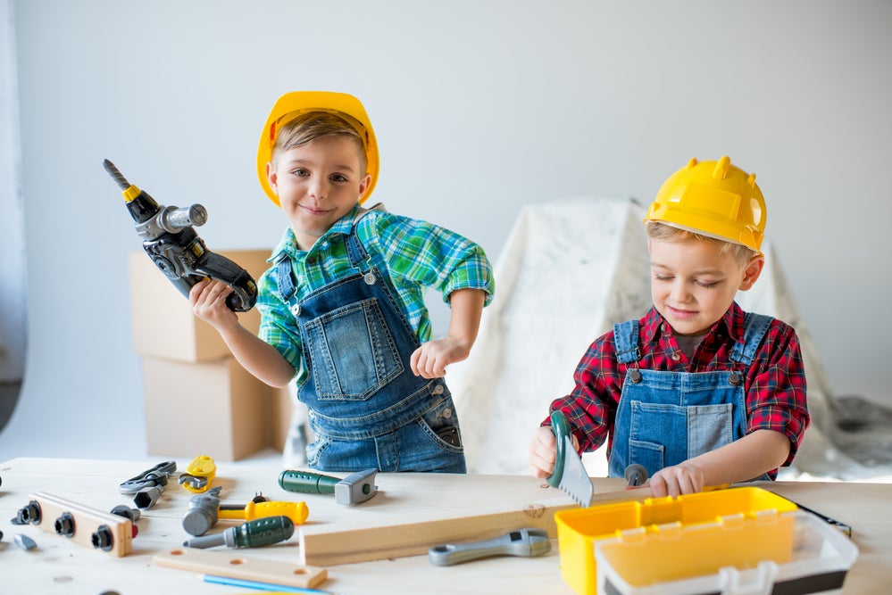 two boys playing with construction toys