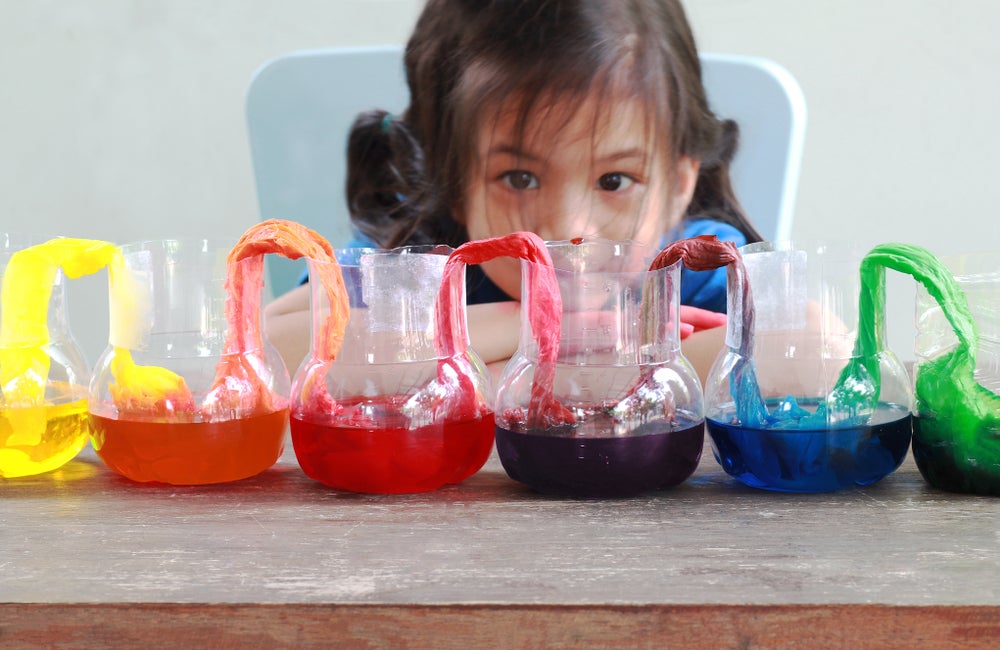 child focusing intently on a science experiment