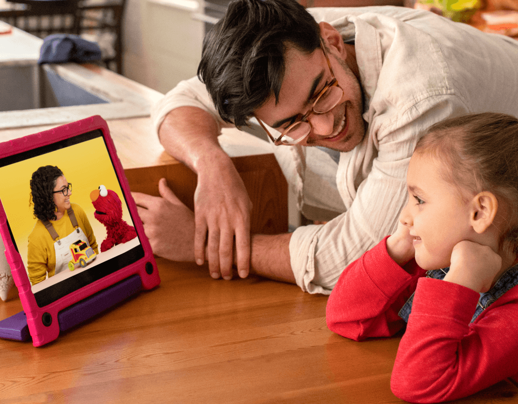 Dad watching a tablet with kid