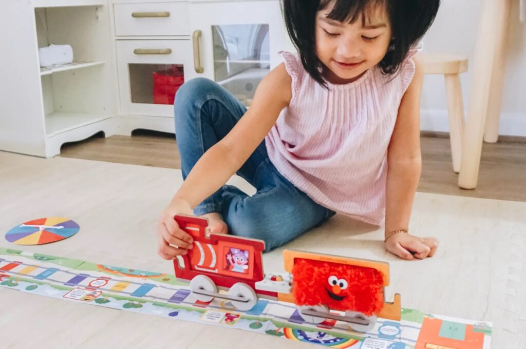 young kid playing with toys for social skills 
