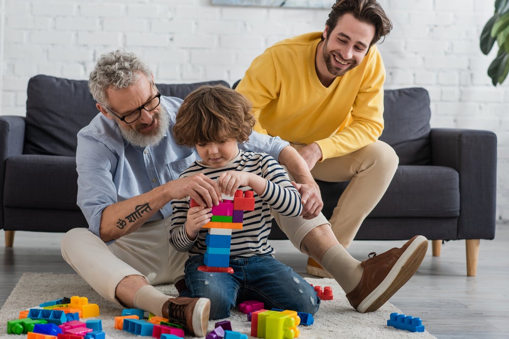 kid playing legos with parents