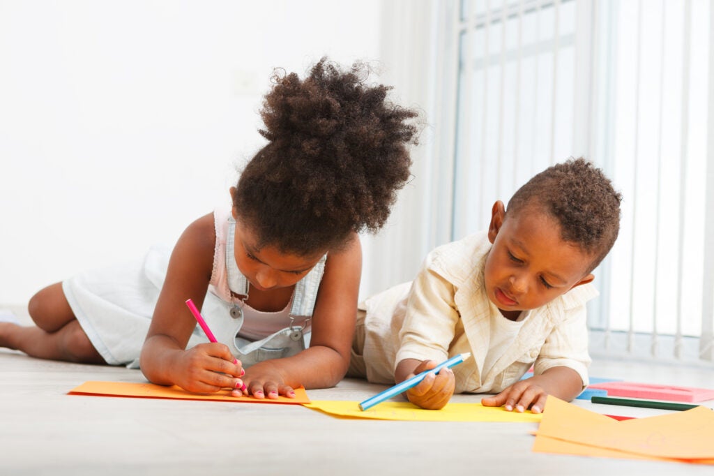 two toddlers writing fun stories