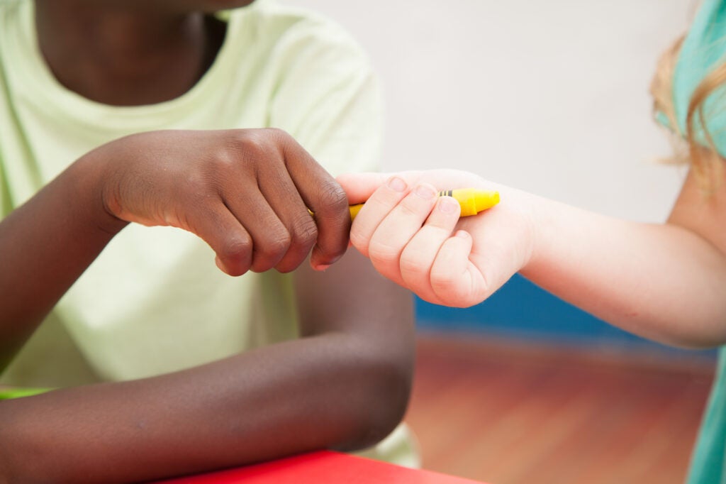 kids sharing a crayon