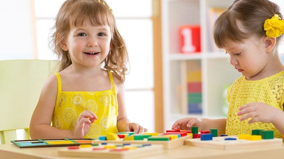 kindergarteners playing with a number puzzle