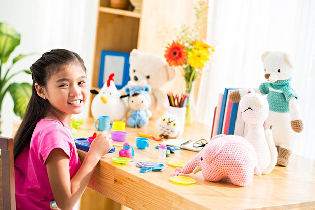 young girl playing with toys