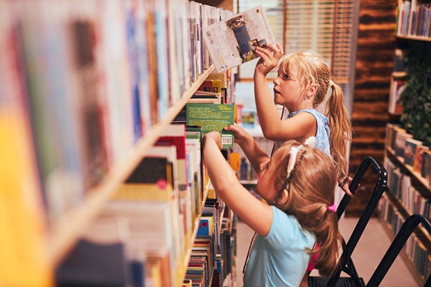 Kids picking out books at the library for 2nd grade reading
