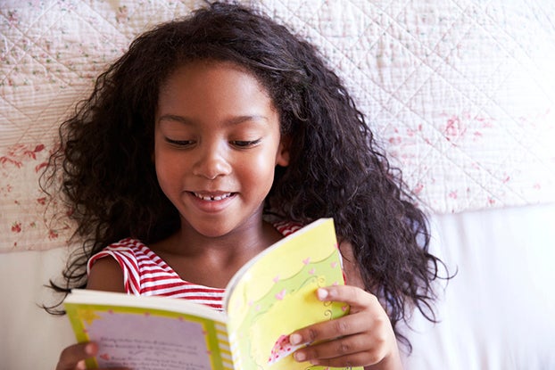 Girl doing her 3rd grade reading
