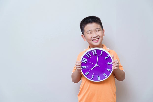 Kid holding a clock