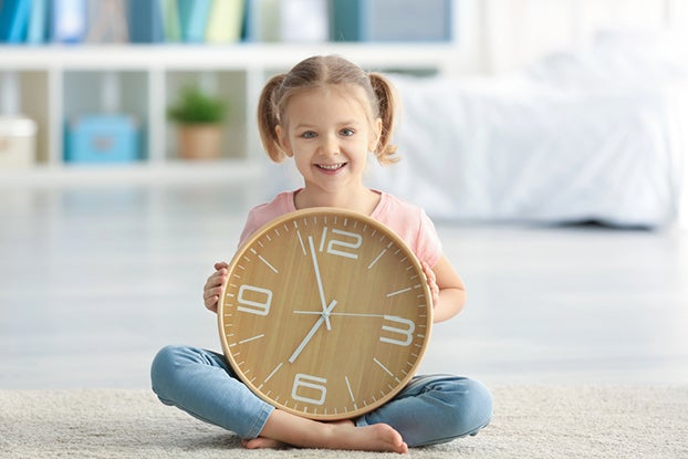 Kid learning how to tell time