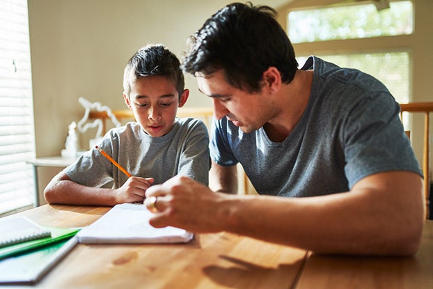 dad helping kid learn how to tell time