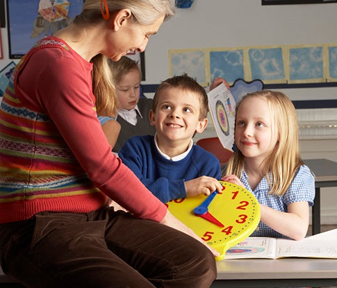 Teacher teaching kids how to tell time