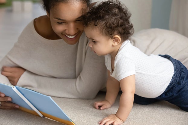 Mom reading aloud to baby