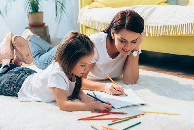 Mom helping kid with the components of reading
